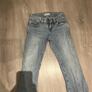 Blåa Gina Tricot Perfect Jeans 34 - Snygga ljusblå jeans från Gina Tricot, modell Perfect Jeans. Klassisk femficksdesign med knappar och bälteshällor, samt bakfickor med lock och knapp. Jeansen har en rak passform och är tillverkade i denim för en cool vardagslook. Jag köpte dom för 500kr i butik, använt dom minst 2-3 ggr.