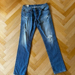 Blåa Abercrombie & Fitch jeans  - Att par raka jeans från  Abercrombie & Fitch med feta slitningar.