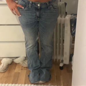 Blå bootcut jeans från Nelly - Säljer ett par blå jeans från Nelly med bootcut passform och normal midja. Jeansen har klassisk femficksdesign, snygga slitningar och detaljerade bakfickor med knapp. Perfekt för dig som gillar en avslappnad och trendig stil. Jag har inte använt dessa men dom är klippta där nere för de va för långe för mig, fortfarande för långa för mig då jag är c 163.