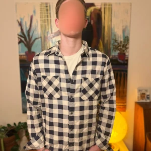 Ralph lauren skjorta - Snygg blåvit rutig skjorta med klassisk krage och knäppning framtill. Skjortan har två bröstfickor med lock och långa ärmar. Perfekt för en avslappnad och trendig stil.