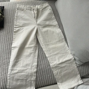 Vita jeans - Snygga vita jeans med vida ben. Byxorna har normalhög midja och är tillverkade i ett stadigt bomullstyg. Perfekta för en clean och fräsch look. Liten missfärgning (se bild) men inget som är märkbart om man inte kollar noga
