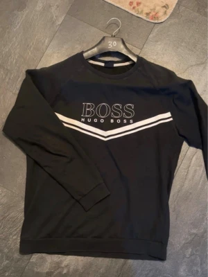 Hugo boss tröja - Fint svart hugo boss tröja. Bra för att bygga ett snyggt outfit. Storlek: S
