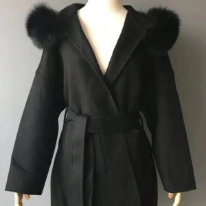 Svart kappa med pälsdetaljer - Snygg svart kappa med breda ärmar och pälsdetaljer på axlarna. Jackan har omlottstängning och med bälte i midjan för en cool siluett. Dock är ”bältehållaren” på ens sidan sönder, så pris diskuteras ❤️