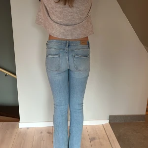 Ljusblå bootcut jeans från Gina Tricot - Lågmidjade jeans från Gina, strl. 152. Det finns en ljus fläck på låret som jag inte har testat att ta bort.