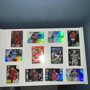 Fotbollskort - Samlaralbum - Samling med 12 coola fotbollskort från världsstjärnor som Pogba, Hazard och Sterling. Perfekt för dig som älskar fotboll och vill ha unika samlarkort med snygg design och glittriga effekter. Passar både unga fans och samlare! Få alla dessa fantastiska fotbollskort för endast 165kr