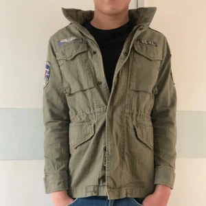 Ralph Lauren Field jacket - En otroligt snygg och eftertraktad field jacket ifrån Ralph Lauren. | en knapp är av men finns kvar, därav priset. |  bra skick. | Kostar cirka 4000-5000 att köpa ny. | Modellen är 180, passar runt 170-182. | Storlek L i ungdom så passar en XS/S. | Hör av er vid frågor!
