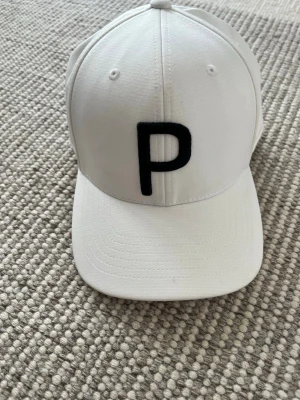 Puma golf keps - Vit Puma golf keps i bra skick har dock lite lätt smuts 