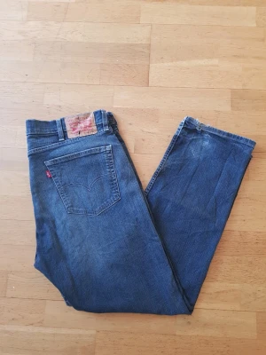 Levi's 505 - Klassiska blå jeans från Levi's med rak passform och femficksmodell. Jeansen har en tydlig röd Levi's-tag på bakfickan och läderpatch i midjan. Tillverkade i slitstark denim med vintagekänsla och normal midja.