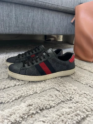 Gucci Ace   - Gucci ace i storlek 40 passar 41-42. Finns en defekt som ni ser på bild 6. Utöver defekt är skorna i bra skick. Endast skorna följs med. Skorna är äkta 