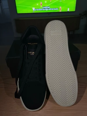 Sneakers Saint Laurent Black 🖤 - These Saint Laurent sneakers feature a sleek black design with a white sole. They appear to be in excellent condition with no visible signs of wear.  ⭐️ Condition: 10/10 🎨 Color: Black 📦 Fast and careful shipping