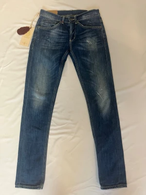 Dondup George  - Tja! Säljer nu dessa sjukt eftertraktade blå  Dondup George med original slitningar från frabrik. Se storlek nedan. Jeansen är i nytt skick!                                                                      Nypris: 3500kr                                                                 Säljs för: 699kr                                                                 Tveka inte på att höra av er vid intresse eller frågor!