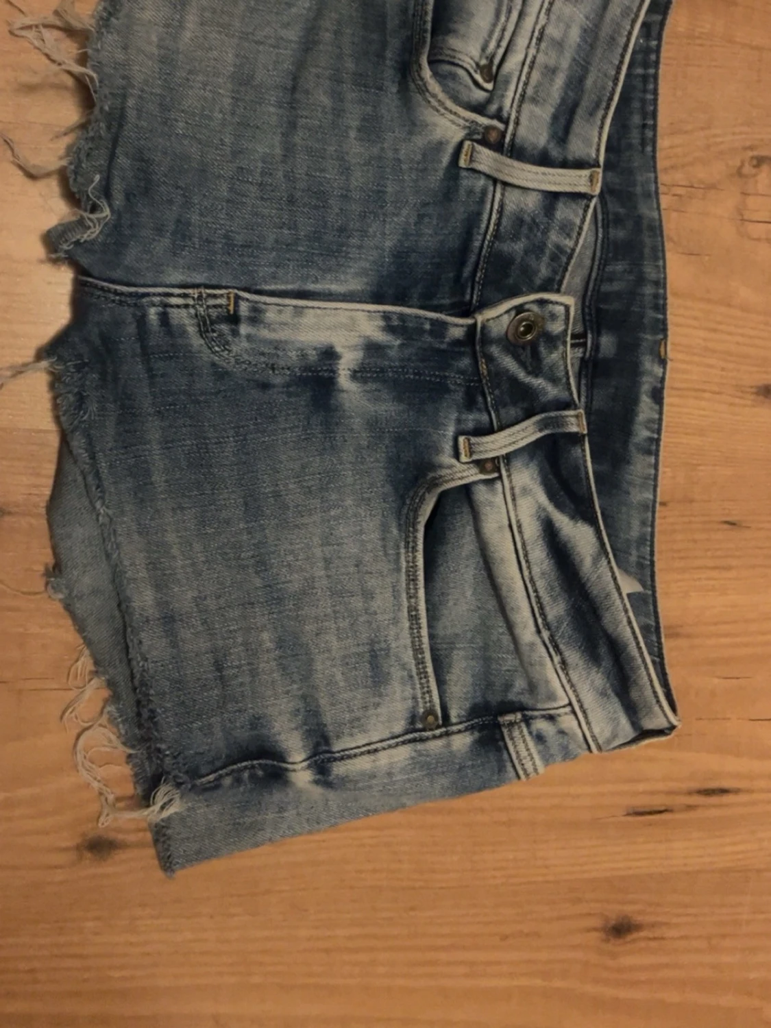 Blå lågmidjade jeansshorts med fransig kant