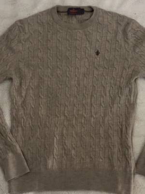 Beige kabelstickad tröja Morris - Egentligen storlek L men råkat krympa den i tvätten passar storlek S. Tröja från Morris använd 1 gång