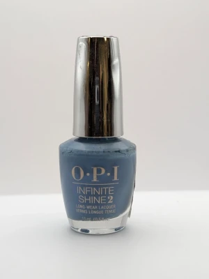 OPI Infinite Shine Check Out the Old Geysirs blå nagellack 90% kvar - OPI Infinite Shine 2 nagellack i nyansen 'Check Out the Old Geysirs'. Färgen är en snygg blågrå ton med krämig finish. Kommer i en klassisk rund glasflaska med silverfärgat lock. Perfekt för dig som gillar trendiga och stilrena naglar.