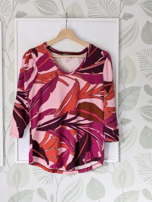 Färgstark Topp Elton Storlek 36-38 - - Tunn skön elastisk topp. - I jättefint skick lite ljusare i de mörkare trycken. - Storlek 36 rekommenderar till större 36-38. - Jag kan ha missat någon miniskavank men jag har försökt att granska så gott det går.. 