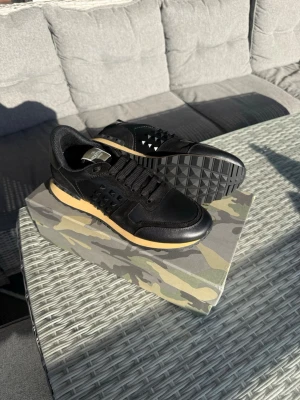 Svarta Valentino Rockrunners - Tja! Säljer dessa svarta valentino rockrunners i storlek 44, perfekta nu inför våren när solen börjar titta fram. Det finns en liten skada på lådan som man kan se på sista bilden! Priset är ej hugget i sten och kan diskuteras. Tveka inte att höra av er vid frågor eller funderingar