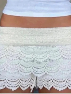 Vita virkade shorts med volang - Säljer ett par populära jättefina vita lågmidjade virkade shorts med flera lager volangdetaljer som jag fortfarande gillar mycket. Köpte från Plick så vet ej var det är från