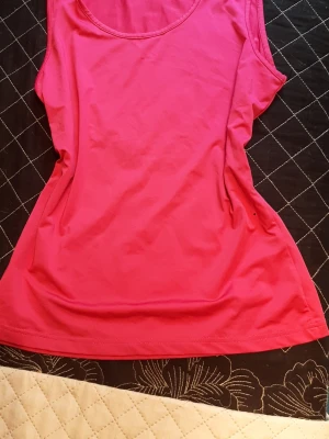 The pink top from Cappuccini  - Cool and pink. In excellent condition. Measurementson pictures, I think it fit for size L too.. 
