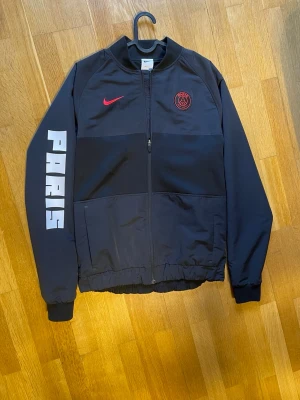 ⚽️ Nike Paris Saint-Germain (PSG) Dri-FIT Bomberjacka - • Märke: Nike (Officiell Paris Saint-Germain merch) • Storlek: Small (S) • Skick: Som ny / Perfekt skick. Endast använd ett fåtal gånger och väl omhändertagen. 