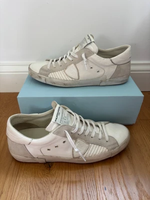 Vita sneakers från Philippe Model - Hej 👋 jag säljer dessa Philippe model. Skorna har inga defekter och är väldigt bra skick. Box ingår storlek 45