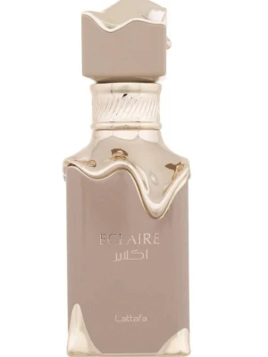 Lattafa Eclaire parfym beige/guld - Lattafa Eclaire parfym i en lyxig beige och guld flaska med unikt vågformat lock och detaljer. Flaskan har en elegant, modern design med metalliska inslag och arabiska inskriptioner. Perfekt för dig som gillar exklusiva dofter och snygg inredningsdetalj.