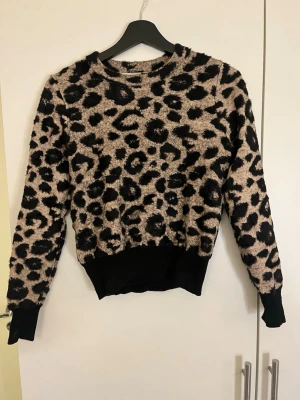 Leopardmönstrad stickad tröja Zara - Säljer en fluffig stickad tröja från Zara med leopardmönster i beige och svart. 