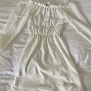 Vit klänning  - Vit sommarklänning med små vita prickar, använd vid 3 tillfällen, fint skick!