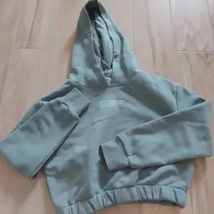 Sage Grön Crop Hoodie från H&M till Barn (Med tryck, text) Jätte skönt och mjukt material. Helt Oanvänd. Storlek: 140