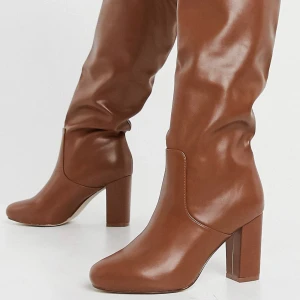 Bruna knähöga dra på- stövlar - Helt oanvända stövlar i dra på modell! Ca 7 cm klack, fake läder i stl 39. Slutar precis vid knäna för mig som är 169 🥰