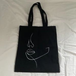 Svart väska - En svart tyg väska med konst motiv, perfekt till skolan, inga skador eller liknande 🫶(har två stycken tillgängliga)