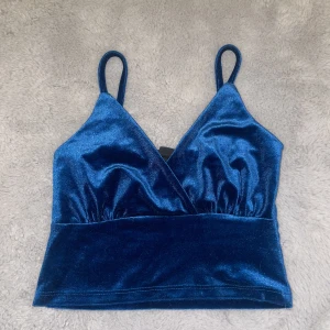 En marinblå topp - En jätte fin topp som sitter jättefint på, den har en liten liten ton av grön som gör färgen jättefin, säljer pga jag har en likadan