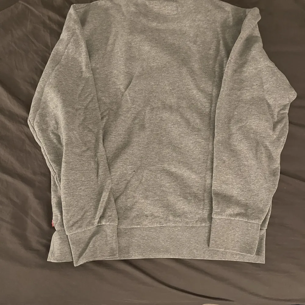 Levis tröja grå den använd några få gånger skrynklig eftersom den legat i en byrålåda den är i bra skick och skön pass form . Tröjor & Koftor.