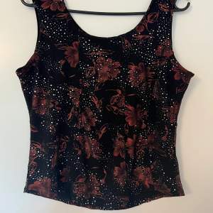 Woman’s corset like tank top blouse with a beautiful flower design and jewels. Y2K vibes & super comfortable and cute!!