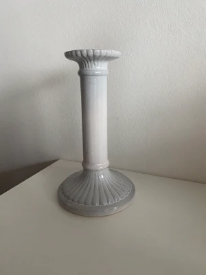 Ljusstake - Stilren och elegant ljusstake i en superfin ljusgrå färg (H: 20cm, B: 11cm). 1 ljusstake 50kr, 2 ljusstakar 80kr, 3 ljusstakar 100kr, 4 ljusstakar 120kr (Fraktkostnaden varierar beroende på antal ljusstakar). 