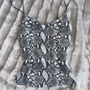 Snake pattern tight top, very flattering. Nice for going out.