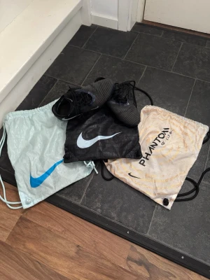 Säljer fotbollsskor och påsar - Tjena säljer ett par elite skor från nike med modellen phantom. Storlek 43 och är konstgräs dobbar. Sedan ingår det även tre elite påsar där den blåa och svarta men speciellt den vita är väldigt exklusiv och eftertraktad. Nikemärket på sulan på ena skon har lossnat lite. Bra skick men lite slitna. 