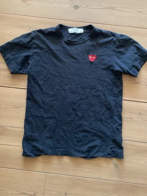 Svart Comme des Garçons Play t-shirt - Säljer en Svart t-shirt från Comme des Garçons Play med det ikoniska röda hjärtat med ögon broderat på bröstet. Klassisk passform. Skriv vid frågor!!! 