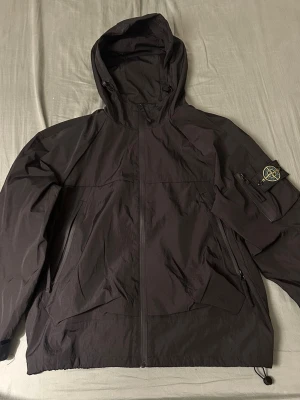 Svart vindjacka från Stone Island - Svart vindjacka med huva från Stone Island. Storlek S, använd runt 2-3 gånger. Pris kan förhandlas