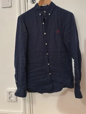Ralph lauren linneskjorta - Snygg mörkblå linneskjorta i strl XS från Ralph Lauren! Hör av dig vid frågor eller liknande!😁