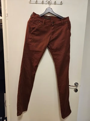 MAC PERSON jeans - Byxor med dragkedja och knappstängning framtill. Byxorna har fickor fram och bak, med en liten dragkedjeförsedd ficka på vardera sida bak.  Nytvättade med parfymfritt tvättmedel.