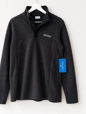 Ny Svart fleece från Columbia - Mjuk och varm svart fleece från Columbia med halvknäppning och ståkrage. Regular fit-modell med diskret logga på bröstet. Perfekt för lager-på-lager och enkel att matcha till olika outfits.