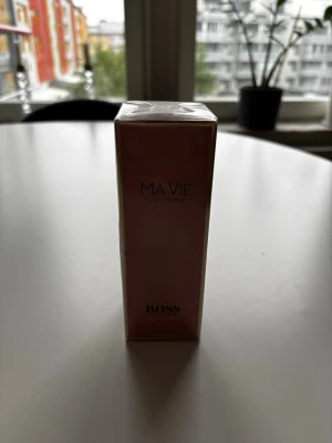 BOSS Ma Vie Pour Femme parfym - Elegant parfym från BOSS, Ma Vie Pour Femme, EDP 50 ml. I  en stilren rosa och guldig förpackning. Doften är feminin och modern, perfekt för dig som gillar fräscha och blommiga toner. 