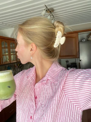 Rosa och vitrandig pyjamaströja - Säljer en mysig pyjamaströja med rosa och vita ränder. Skjortmodellen har krage, knappar framtill och långa ärmar. Perfekt för chill dagar hemma eller när du vill ha det extra bekvämt.