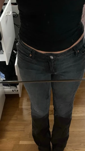 Svarta bootcut jeans  - Säljer ett par svarta bootcut jeans med låg midja. Jeansen har klassisk femficksmodell och knappgylf. Materialet är denim. Perfekta till en avslappnad och trendig look.