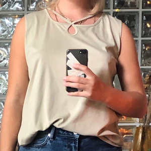 Beige linne - Helt oanvänt beige vackert linne. Säljer pga inte alls min färg, men skitsnygg modell!! Enkelt men kul med detaljen i halsen💕