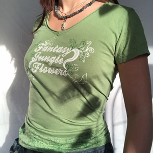 Grön fairycore T-shirt  - OM ANNONSEN FINNS KVAR FINNS PLAGGET KVAR! Helt underbar grön T-shirt med fint tryck. Visas på en s men passar både större och mindre beroende på önskad passform. Köpare står för 48kr frakt. Defektfritt second hand skick. Inga bud än så direktköp gäller! 