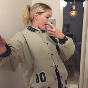 Collage jacka  - Collage jacka med fake läder på armarna. I väldigt bra kvalitet, däremot har en knapp trillat av (se bild 3). Storlek 34 men passar XS-m då den är mycket oversized 