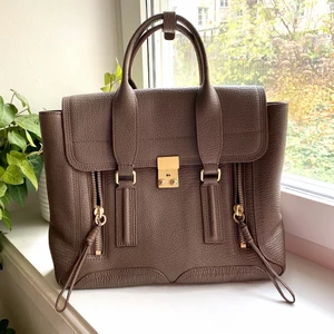 3.1 Phillip Lim väska - Väska från 3.1 Phillip Lim i färgen Taupe (säljs inte längre i denna färg). Köpt på Illum i Köpenhamn för 6270 DKK, cirka 8500 SEK. Säljs idag på Zalando och boozt för över 9000kr. Som ny förutom några små repor på låset som bara syns på väldigt nära håll