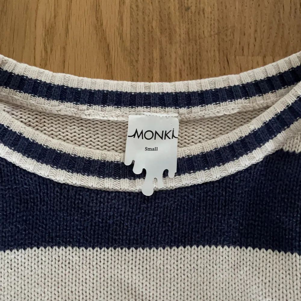 Stickad tröja från Monki, använd ett fåtal gånger. Den är randig med mörkblå och vita ”ränder”. Den är kort i modell, inte jättekort men slutar under naveln typ. Köpt för 350. Stickat.