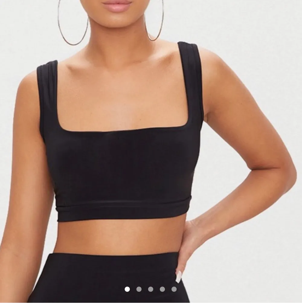FREE TRACKED SHIPPING.   Featuring a black slinky material and a round neckline, this simple soft crop top is an essential in any wardrobe.  Length approx 34cm/13.5